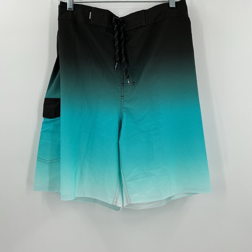 Rokka&Rolla men's 4-way stretch swim trunks featuring a black-to-teal ombre fade